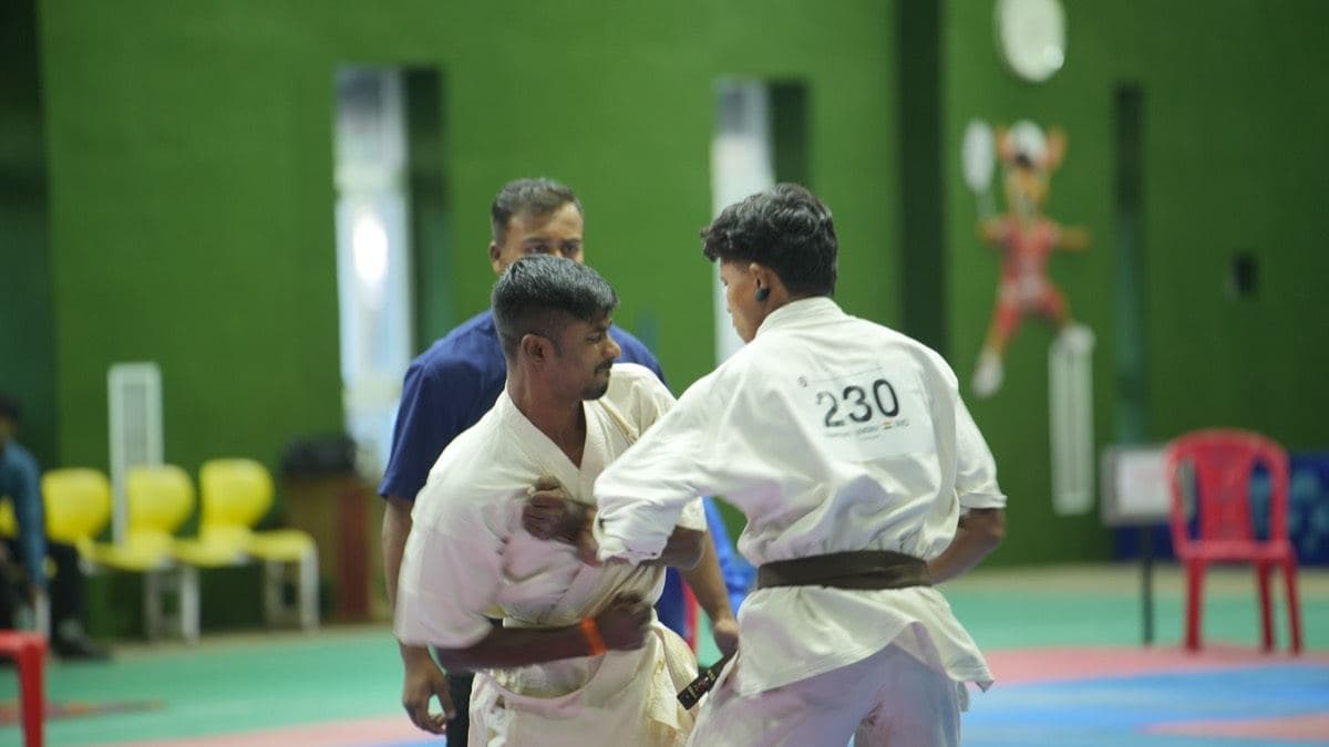 Karateka in white gi on the mats at a KKFI tournament